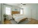 Bright bedroom with wood headboard, ceiling fan, and hardwood floors provides a comfortable and inviting space at 206 Pine St, Fuquay Varina, NC 27526