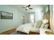Bright bedroom with wood headboard, ceiling fan, and hardwood floors provides a comfortable and inviting space at 206 Pine St, Fuquay Varina, NC 27526