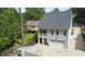 The home's garage, screened in deck and surrounding trees are featured in this listing photo at 206 Pine St, Fuquay Varina, NC 27526