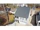 A well-maintained gray home featuring a two-car garage and a screened-in porch at 206 Pine St, Fuquay Varina, NC 27526