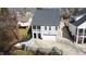 A gray two-story house with a two-car garage and a cozy, fenced outdoor seating area at 206 Pine St, Fuquay Varina, NC 27526