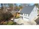 View of a light gray two-story house featuring a garage, backyard seating area, and landscaping at 206 Pine St, Fuquay Varina, NC 27526