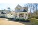 Charming home with inviting front porch, featuring a quaint blue door and neat landscaping at 206 Pine St, Fuquay Varina, NC 27526