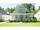 Charming home features a covered porch, well-maintained lawn, and inviting curb appeal at 206 Pine St, Fuquay Varina, NC 27526