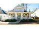 Charming home featuring a light blue door, inviting front porch and beautifully landscaped front yard at 206 Pine St, Fuquay Varina, NC 27526