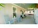 Charming porch featuring rocking chairs, hanging plants, and a quaint blue ceiling at 206 Pine St, Fuquay Varina, NC 27526