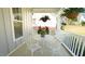 Charming porch with decorative wrought iron table/chairs and hanging plants for outdoor relaxation at 206 Pine St, Fuquay Varina, NC 27526