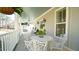 Charming front porch with wrought iron table and chairs under a blue ceiling at 206 Pine St, Fuquay Varina, NC 27526