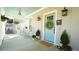 Charming porch featuring rocking chairs, hanging plants, and a quaint blue door at 206 Pine St, Fuquay Varina, NC 27526