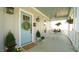 Charming front porch featuring a blue door, and wrought iron table and chairs at 206 Pine St, Fuquay Varina, NC 27526