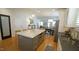 Open kitchen with stainless appliances, a large center island, and views to dining and living areas at 206 Pine St, Fuquay Varina, NC 27526