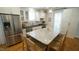 Kitchen features a large center island with seating, stainless appliances, and white cabinetry at 206 Pine St, Fuquay Varina, NC 27526