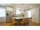 Spacious kitchen boasts a granite island with seating, stainless steel appliances, and white cabinetry at 206 Pine St, Fuquay Varina, NC 27526