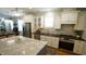 Bright kitchen with granite counters, stainless appliances, and large center island at 206 Pine St, Fuquay Varina, NC 27526