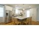 Kitchen with a central granite island, stainless steel appliances, and white cabinets at 206 Pine St, Fuquay Varina, NC 27526