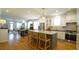 Open floor plan, kitchen with stainless steel appliances, bar stool seating, and hardwood flooring at 206 Pine St, Fuquay Varina, NC 27526