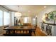 Bright kitchen and dining area with hardwood floors, stainless steel appliances, and a large wooden table at 206 Pine St, Fuquay Varina, NC 27526