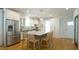 Bright kitchen features a granite island with seating, stainless steel appliances, and white cabinetry at 206 Pine St, Fuquay Varina, NC 27526