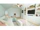 Bright living room with built-in shelving, a comfortable sofa, and a light-filled atmosphere at 206 Pine St, Fuquay Varina, NC 27526