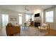 Bright living room featuring hardwood floors, a fireplace, large windows, and elegant furnishings at 206 Pine St, Fuquay Varina, NC 27526
