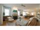 Inviting living room featuring a fireplace, hardwood floors, and an open layout connecting to the dining area at 206 Pine St, Fuquay Varina, NC 27526