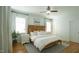 Bright main bedroom with hardwood floors, ceiling fan, and natural light at 206 Pine St, Fuquay Varina, NC 27526