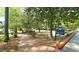 Inviting view of Fuquay Mineral Spring Park with paved paths and lush greenery at 206 Pine St, Fuquay Varina, NC 27526