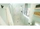 Modern bathroom shower featuring elegant glass doors, tiled walls, and sleek hardware at 206 Pine St, Fuquay Varina, NC 27526
