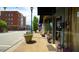 Storefront on a brick sidewalk with flower planters and benches at 206 Pine St, Fuquay Varina, NC 27526