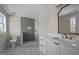 Bathroom with white vanity, gold fixtures, framed mirror, and a walk-in shower featuring vertical tiles at 207 Holleman St, Apex, NC 27502