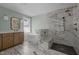 Beautiful bathroom featuring marble floors, standalone tub, and spacious shower with gold fixtures and built-in bench at 207 Holleman St, Apex, NC 27502