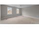Empty bedroom with two windows providing ample natural light and blank canvas for personalization at 207 Holleman St, Apex, NC 27502