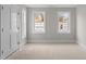 Bedroom with two windows offering natural light, ready for personalization and transformation at 207 Holleman St, Apex, NC 27502