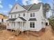 Charming two-story home features a classic design with a covered porch and detailed trim at 207 Holleman St, Apex, NC 27502