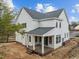 Rear exterior elevation of a two-story home showcasing the deck, white siding, and newly installed roof at 207 Holleman St, Apex, NC 27502