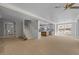 Open-concept living space with wood floors, large windows, and views into the kitchen at 207 Holleman St, Apex, NC 27502