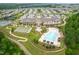 Aerial view of the community clubhouse, tennis courts, pool, and surrounding homes at 216 Kalmia Dr, Durham, NC 27703