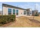 Back of house with manicured yard and concrete patio at 216 Kalmia Dr, Durham, NC 27703
