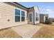 Back of home with concrete patio, windows, and door at 216 Kalmia Dr, Durham, NC 27703