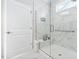 Tiled walk-in shower with built-in seating, glass door, and tiled walls at 216 Kalmia Dr, Durham, NC 27703