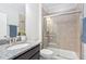 Bathroom featuring tile shower with glass door, granite counters and dark cabinets at 216 Kalmia Dr, Durham, NC 27703