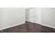 Bedroom with double doors, and hardwood floors at 216 Kalmia Dr, Durham, NC 27703