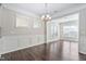 Elegant dining room with natural light and classic wainscoting at 216 Kalmia Dr, Durham, NC 27703