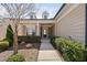 Inviting front porch with manicured bushes lining the sidewalk to the front door at 216 Kalmia Dr, Durham, NC 27703