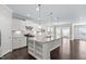 Modern kitchen with a large island, granite countertops, and dark hardwood floors at 216 Kalmia Dr, Durham, NC 27703