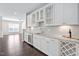Beautiful kitchen with granite countertops, built-in wine fridge, and dark hardwood floors at 216 Kalmia Dr, Durham, NC 27703