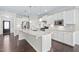 Well-lit kitchen featuring stainless appliances, granite countertops, and a large island at 216 Kalmia Dr, Durham, NC 27703