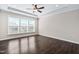 Light-filled main bedroom with a ceiling fan and tray ceiling at 216 Kalmia Dr, Durham, NC 27703