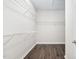 Walk-in closet with built-in shelving and hardwood flooring at 216 Kalmia Dr, Durham, NC 27703