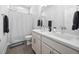 Bathroom featuring a double sink vanity with white cabinetry, tile floor, and a shower/tub combo at 2404 Glade Mill Ct, Fuquay Varina, NC 27526